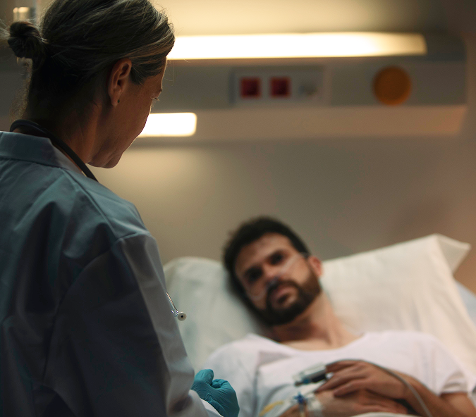 Doctor talking to patient in hospital bed